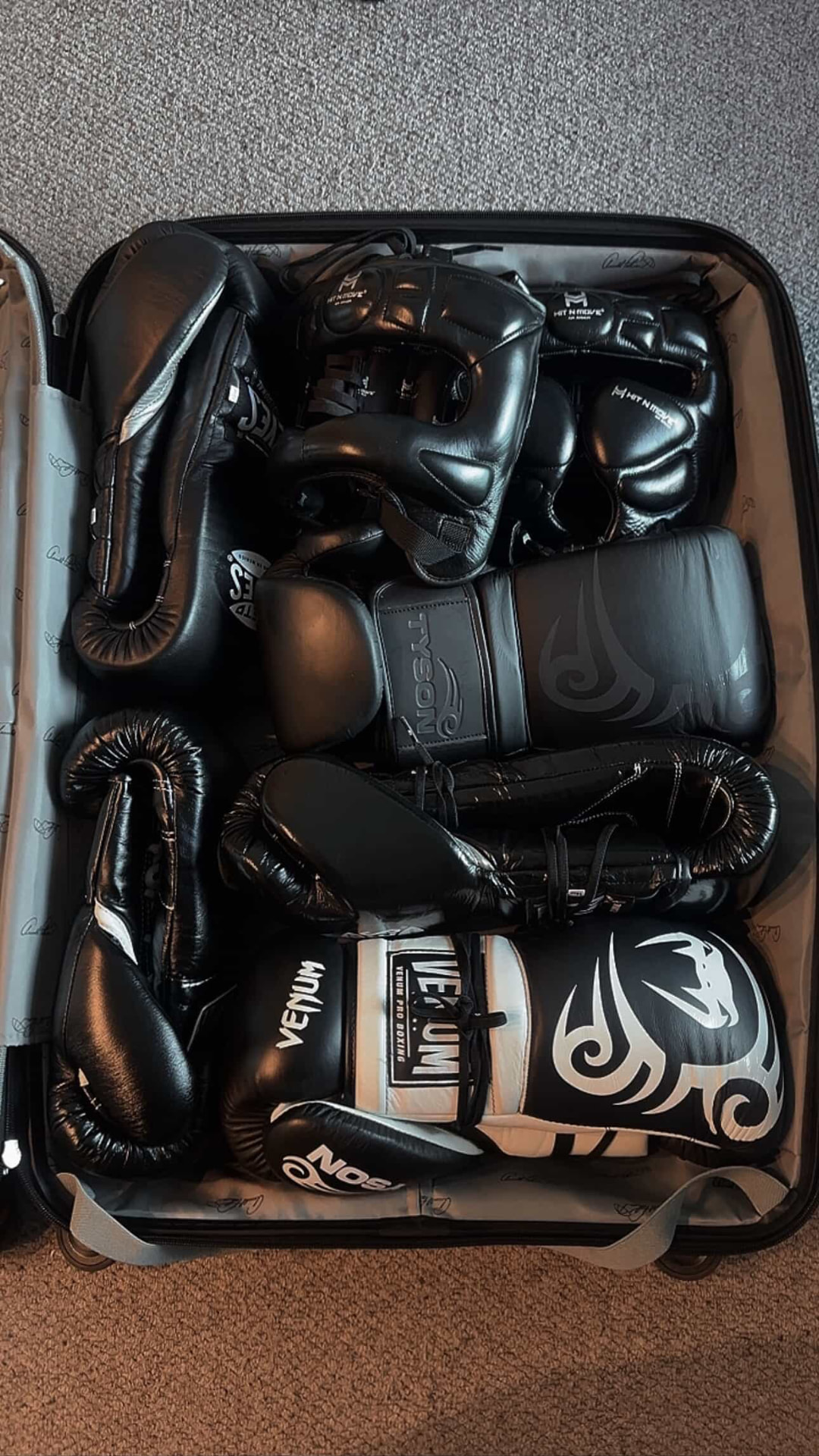 A fighter's own gloves, headgear and shin guards packed in a case, ready for Primal visual customisation.