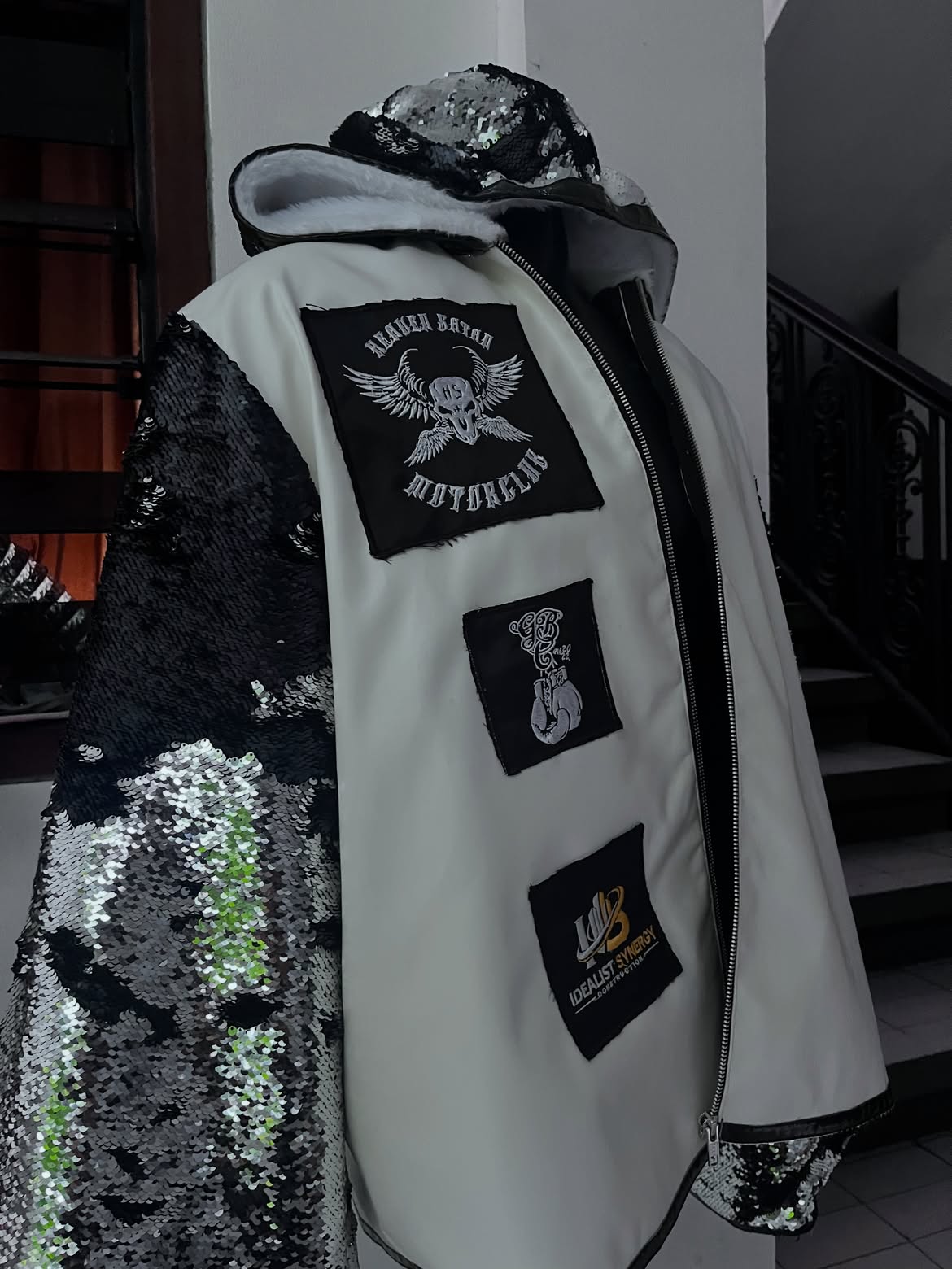 Black and white walkout jacket with sequin sleeves and custom patches.