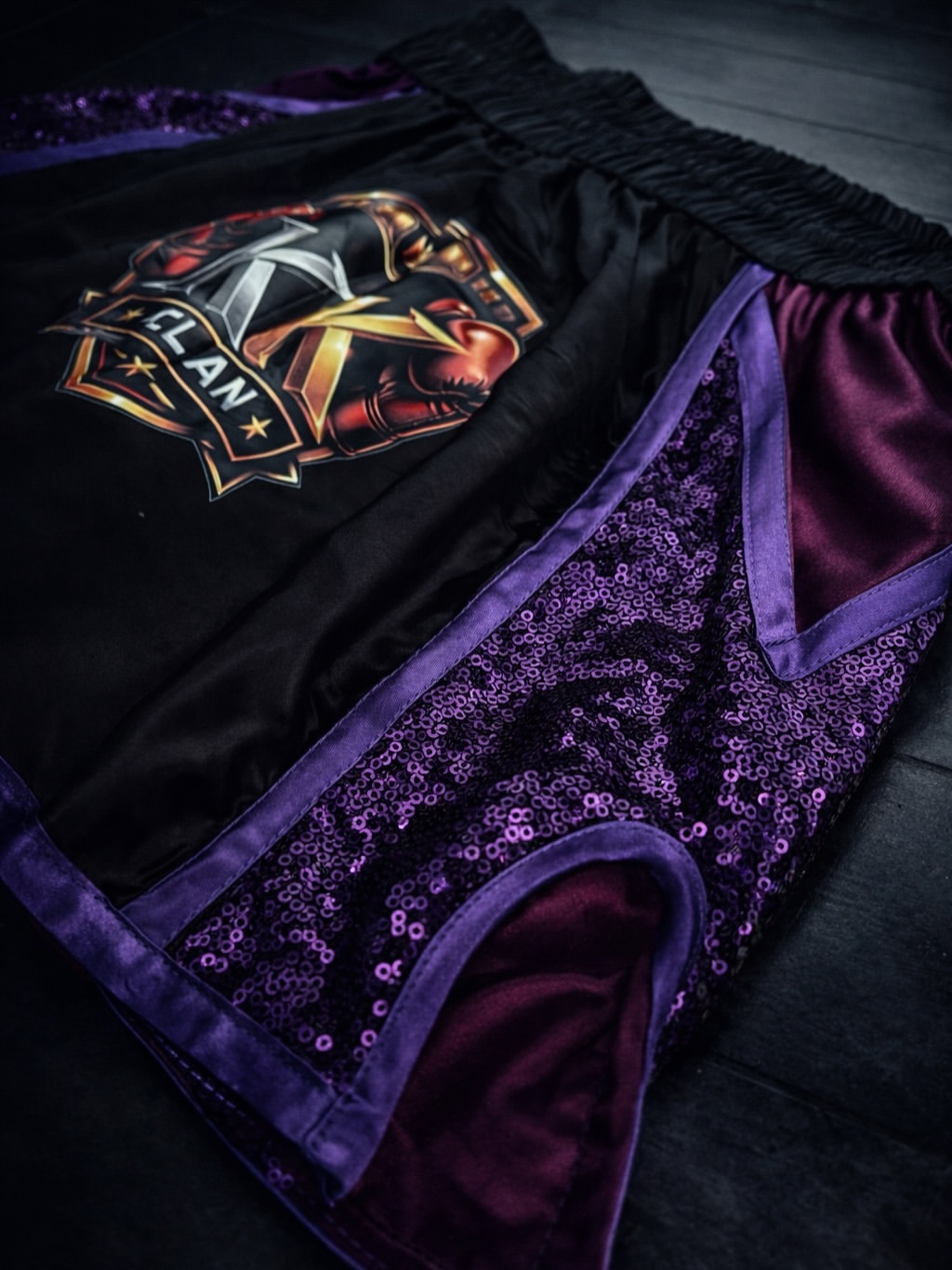 Black and purple custom KK Sam Muay Thai shorts, back view